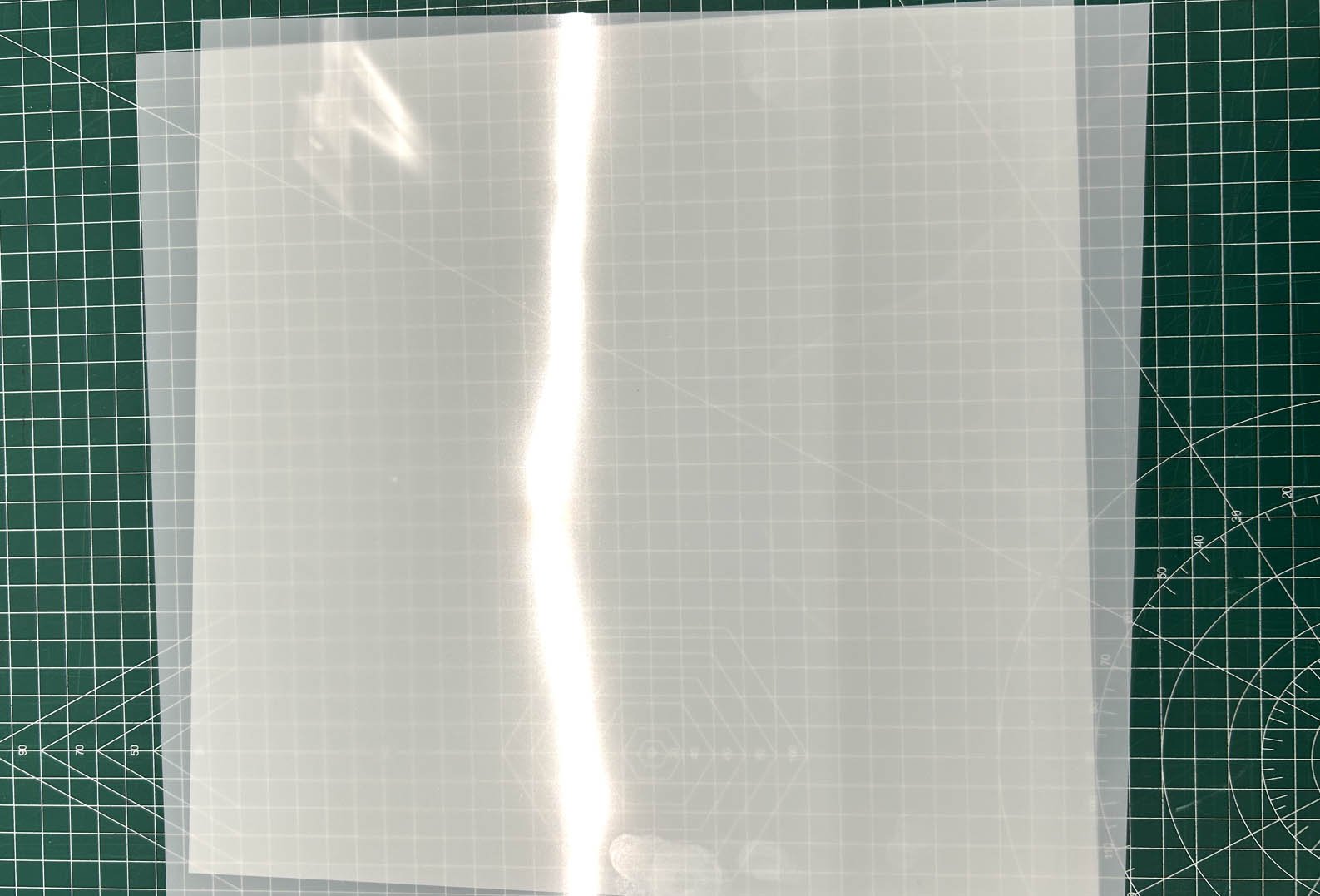 semi transperant mylar sheet on grid background